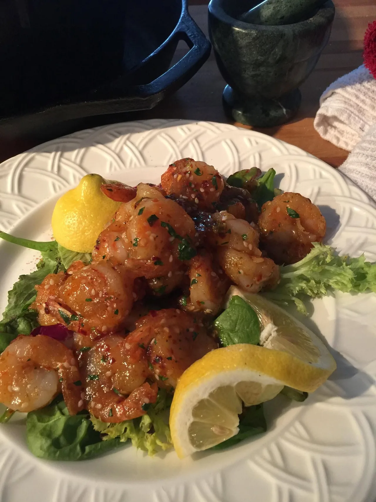 Plated shrimp with lemon and greens